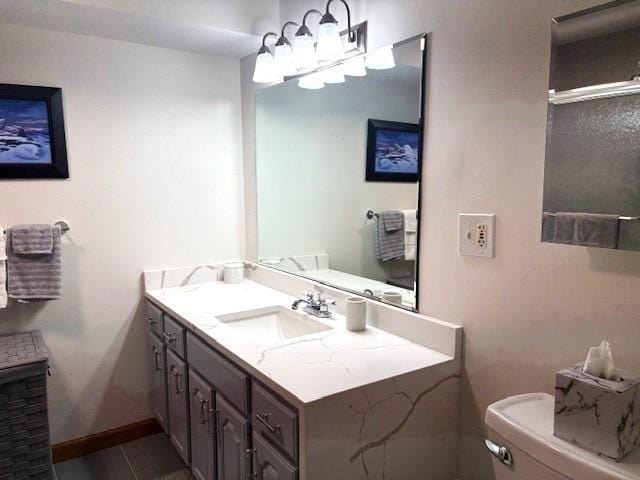 66 Schooner Lndg Unit 66, Hampton, NH 03842 - bathroom featuring toilet, vanity, baseboards, and a shower with shower door