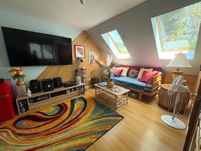 66 Schooner Lndg Unit 66, Hampton, NH 03842 - living room with a skylight, wood finished floors, and wood walls