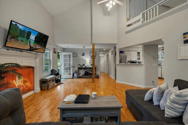 452 Nathan Ellis Hwy, Mashpee, MA 02649 - living area with a high ceiling, ceiling fan, wood finished floors, and a lit fireplace