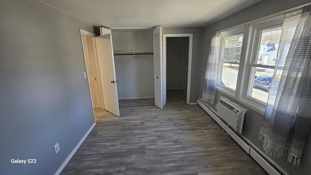 unfurnished bedroom featuring a closet, baseboards, and dark wood finished floors