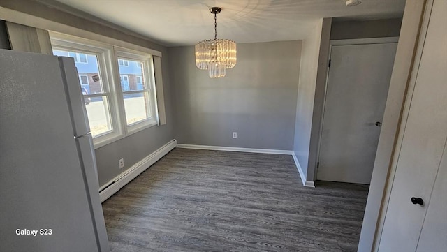 unfurnished dining area featuring baseboard heating, an inviting chandelier, baseboards, and wood finished floors