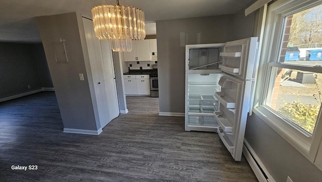 corridor featuring baseboards, an inviting chandelier, dark wood-style floors, and a healthy amount of sunlight