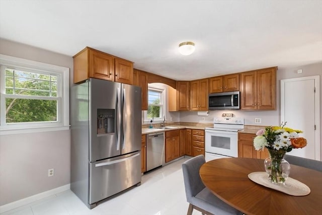 30 Shawnee, Pepperell, MA 01463 - kitchen featuring appliances with stainless steel finishes, light countertops, and brown cabinetry