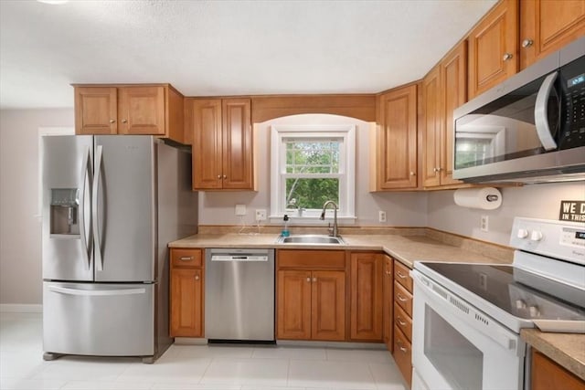 30 Shawnee, Pepperell, MA 01463 - kitchen with stainless steel appliances, brown cabinetry, and light countertops