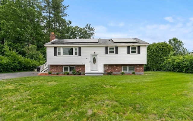 30 Shawnee, Pepperell, MA 01463 - bi-level home with solar panels, a front yard, brick siding, and a chimney