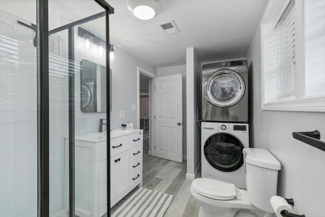 30 Shawnee, Pepperell, MA 01463 - full bath featuring stacked washer / drying machine, wood finished floors, a stall shower, and vanity