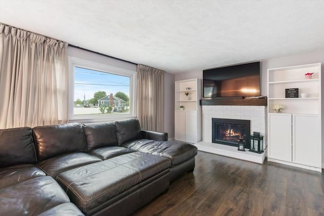 30 Shawnee, Pepperell, MA 01463 - living area featuring dark wood-style flooring, a fireplace, and built in features