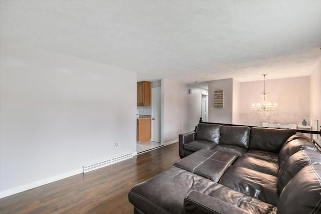 30 Shawnee, Pepperell, MA 01463 - living room with a chandelier and dark wood-style flooring