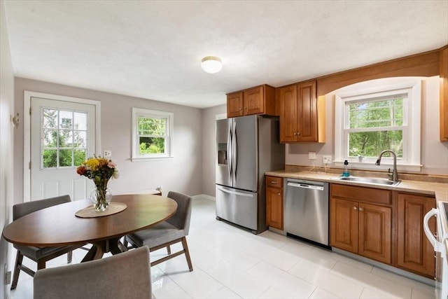 30 Shawnee, Pepperell, MA 01463 - kitchen featuring stainless steel appliances, brown cabinetry, light countertops, and light tile patterned floors