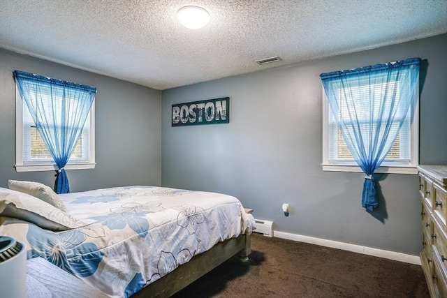 bedroom with dark carpet, a baseboard radiator, a textured ceiling, and baseboards