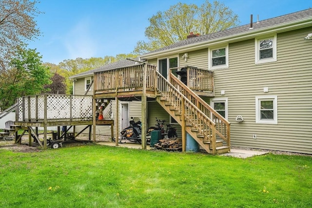 back of property with stairway, a wooden deck, a chimney, and a yard
