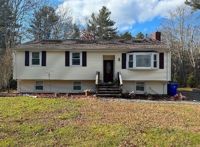 raised ranch with a front lawn