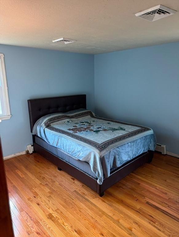 bedroom featuring wood-type flooring