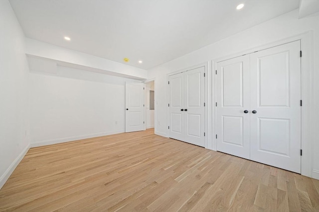 1135-1137 Hyde Park Ave Unit 1, Boston, MA 02136 - unfurnished bedroom with two closets, light wood finished floors, baseboards, and recessed lighting