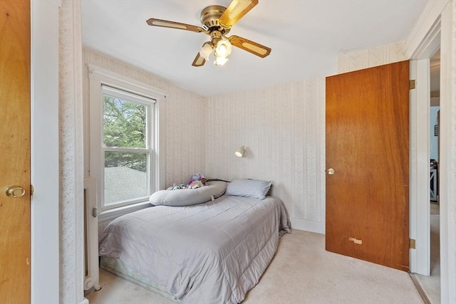 bedroom featuring carpet, wallpapered walls, and ceiling fan