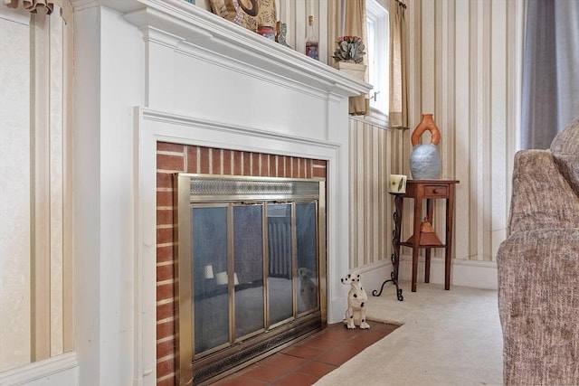 detailed view of a brick fireplace and carpet flooring