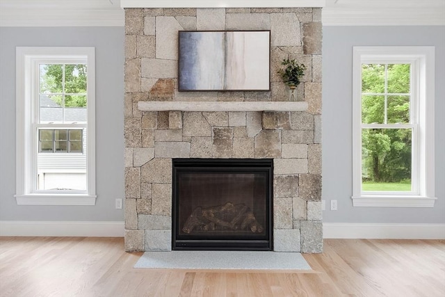 192 Tahattawan, Littleton, MA 01460 - detailed view of a fireplace, crown molding, baseboards, and wood finished floors