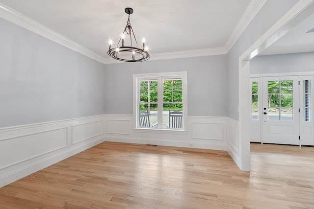192 Tahattawan, Littleton, MA 01460 - spare room with a chandelier, a wainscoted wall, ornamental molding, and light wood finished floors