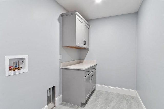 192 Tahattawan, Littleton, MA 01460 - washroom with cabinet space, hookup for a washing machine, and baseboards