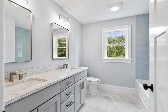 192 Tahattawan, Littleton, MA 01460 - bathroom with double vanity, toilet, marble finish floors, and baseboards