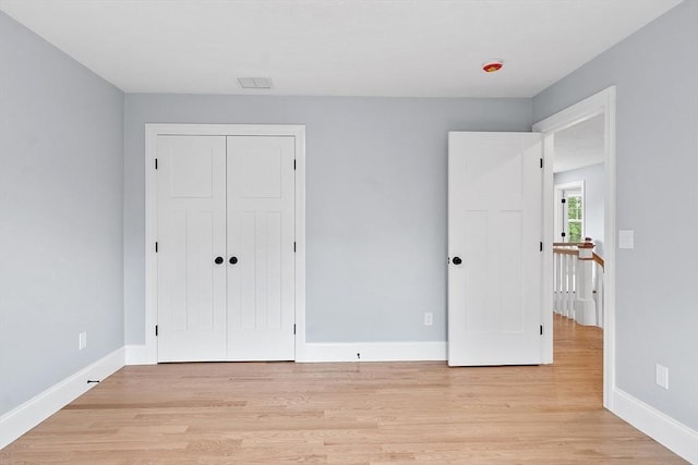 192 Tahattawan, Littleton, MA 01460 - unfurnished bedroom featuring light wood-type flooring, baseboards, and a closet