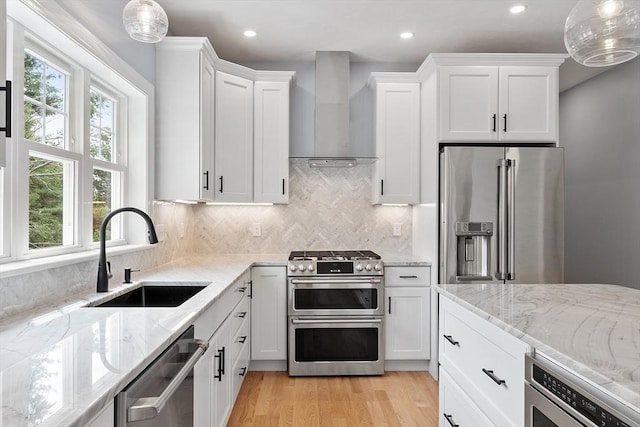 192 Tahattawan, Littleton, MA 01460 - kitchen with stainless steel appliances, wall chimney exhaust hood, a sink, plenty of natural light, and recessed lighting