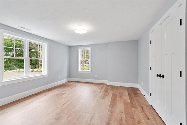 192 Tahattawan, Littleton, MA 01460 - unfurnished bedroom with light wood-type flooring and baseboards