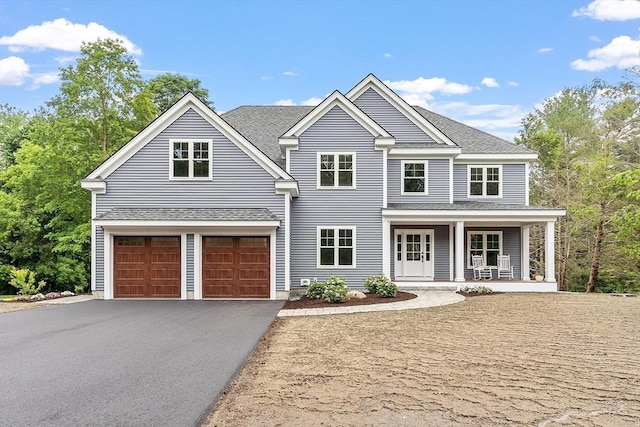 192 Tahattawan, Littleton, MA 01460 - view of front of house featuring a garage, a porch, driveway, and roof with shingles