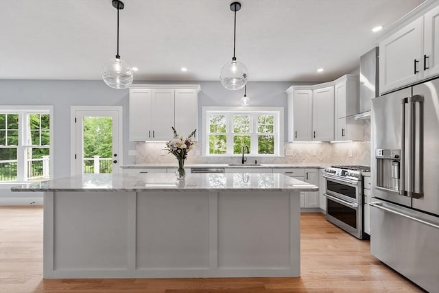192 Tahattawan, Littleton, MA 01460 - kitchen with appliances with stainless steel finishes, wall chimney exhaust hood, a sink, healthy amount of natural light, and recessed lighting