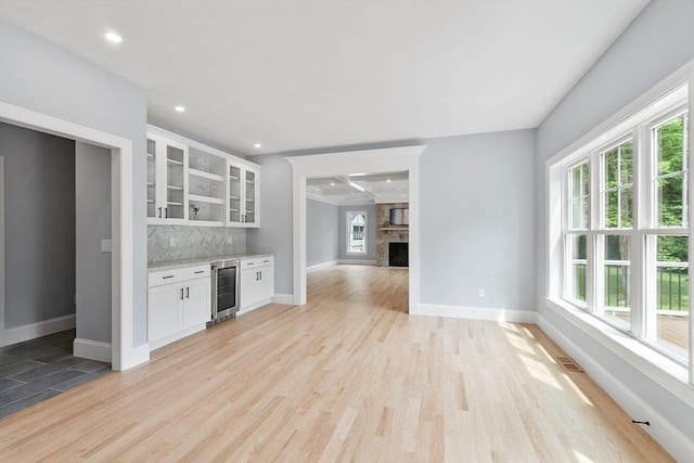 192 Tahattawan, Littleton, MA 01460 - indoor dry bar with wine cooler, healthy amount of natural light, baseboards, backsplash, and recessed lighting