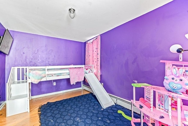 bedroom with baseboards and wood finished floors