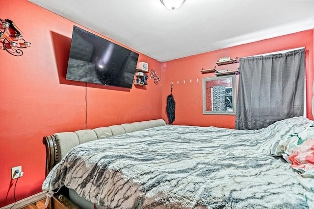 bedroom featuring wood finished floors