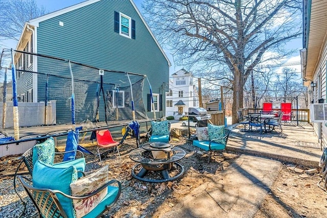 view of patio featuring outdoor dining area, a fire pit, and a grill