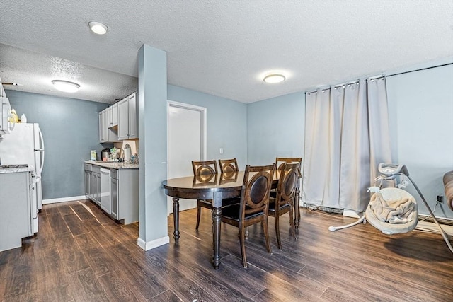 dining area featuring baseboards, a textured ceiling, and dark wood-style floors