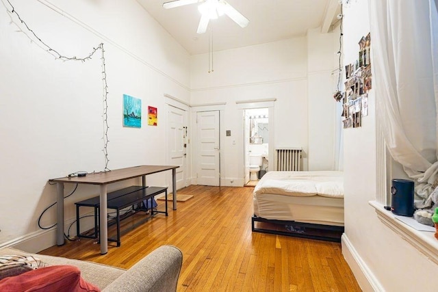 8 Garrison St Unit 110, Boston, MA 02116 - bedroom featuring light wood-type flooring, radiator heating unit, and connected bathroom