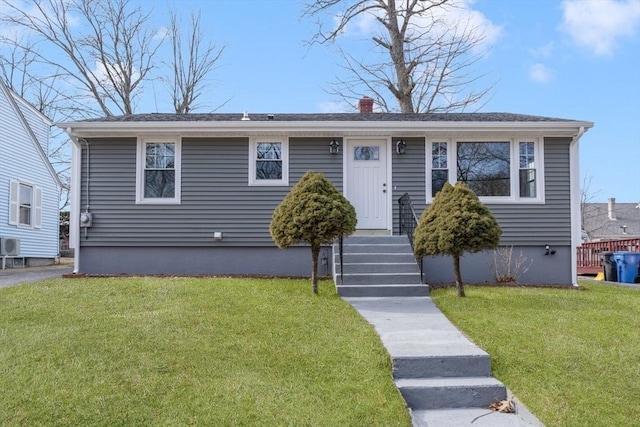 bungalow featuring a chimney and a front lawn