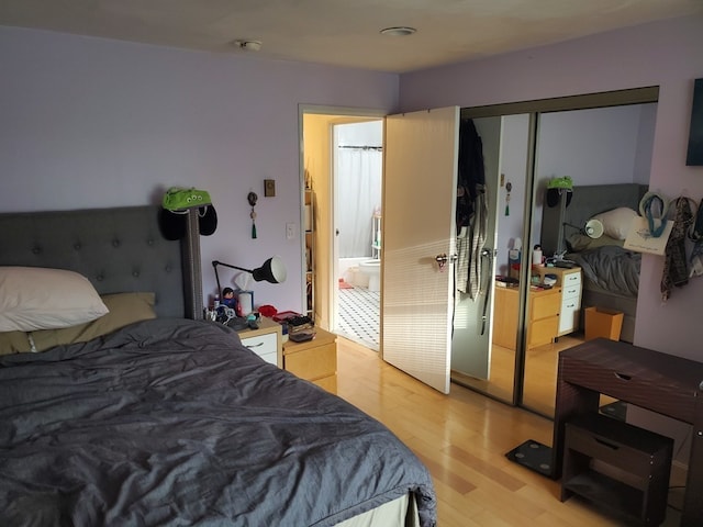 bedroom featuring light wood-type flooring and a closet