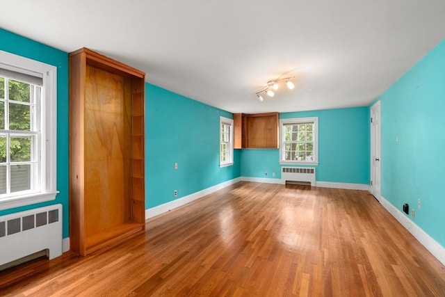 65 Kirkstall Rd, Newton, MA 02460 - unfurnished room with radiator and wood finished floors