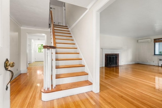 65 Kirkstall Rd, Newton, MA 02460 - staircase with a wall unit AC, ornamental molding, plenty of natural light, and wood finished floors