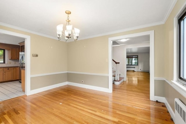 65 Kirkstall Rd, Newton, MA 02460 - unfurnished room with radiator heating unit, light wood-style flooring, plenty of natural light, and ornamental molding