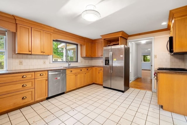 65 Kirkstall Rd, Newton, MA 02460 - kitchen with appliances with stainless steel finishes, tasteful backsplash, plenty of natural light, and light tile patterned floors