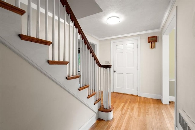 65 Kirkstall Rd, Newton, MA 02460 - entryway featuring hardwood / wood-style floors, stairway, and ornamental molding