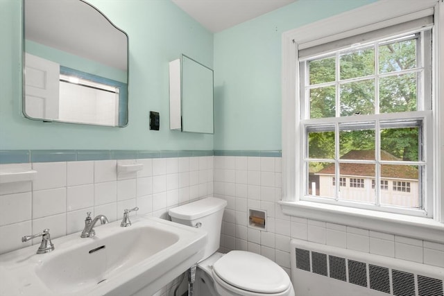 65 Kirkstall Rd, Newton, MA 02460 - bathroom featuring radiator, healthy amount of natural light, tile walls, and a wainscoted wall