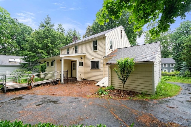 65 Kirkstall Rd, Newton, MA 02460 - back of house featuring a chimney and roof with shingles