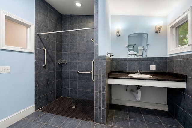 65 Kirkstall Rd, Newton, MA 02460 - bathroom featuring tiled shower, tile patterned flooring, vanity, and tile walls