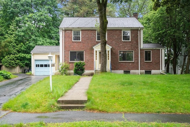 65 Kirkstall Rd, Newton, MA 02460 - colonial house with an attached garage, asphalt driveway, a front yard, and a chimney
