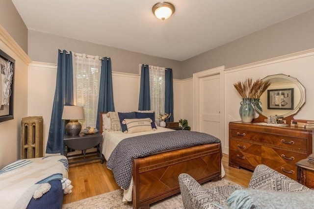 44 Fairview St, Fitchburg, MA 01420 - bedroom featuring radiator heating unit and wood finished floors