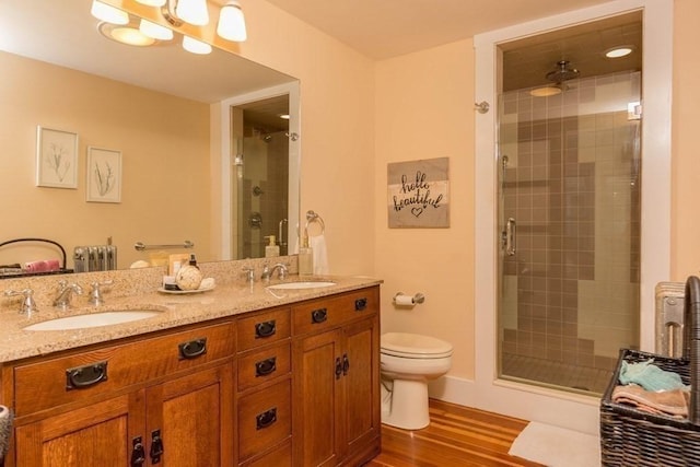 44 Fairview St, Fitchburg, MA 01420 - bathroom with toilet, a sink, a stall shower, and wood finished floors
