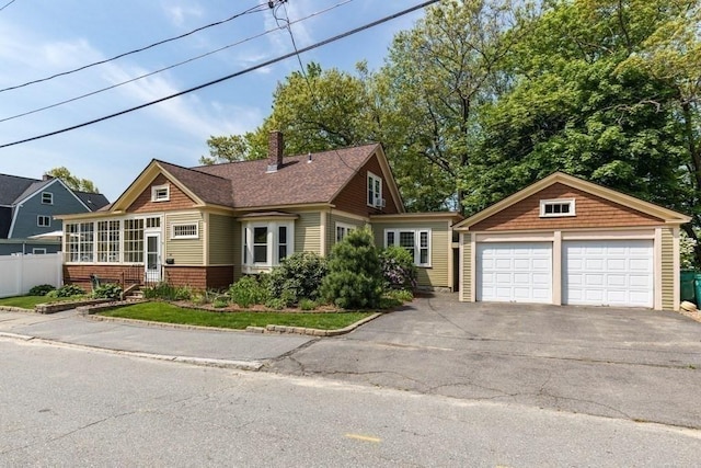 44 Fairview St, Fitchburg, MA 01420 - view of front of house featuring an outdoor structure, a chimney, a sunroom, a garage, and fence