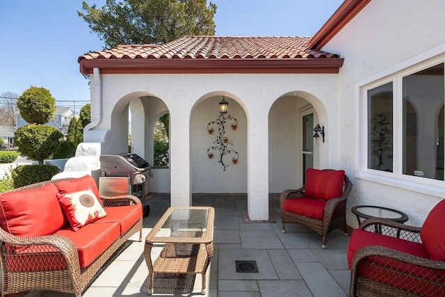 view of patio with an outdoor hangout area and grilling area